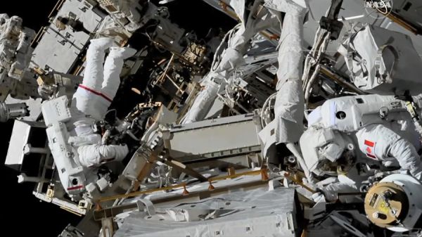 SPACEWALKING ASTRONAUTS BATTLE STUCK PANEL, WRANGLE CABLES ON SPACE STATION
