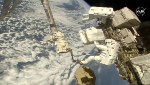 ASTRONAUTS REPAIR COSMIC RAY DETECTOR OUTSIDE INTERNATIONAL SPACE STATION