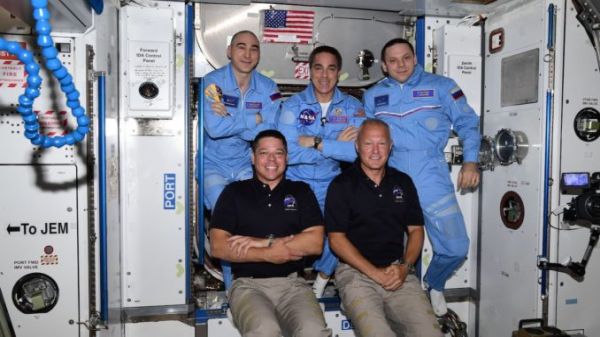 MAKING HISTORY, ASTRONAUTS RIDE COMMERCIAL CAPSULE TO SPACE STATION