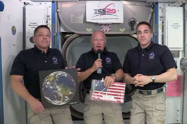 ASTRONAUTS 'CAPTURE THE FLAG' FOR SPACEX IN RACE TO REACH SPACE STATION