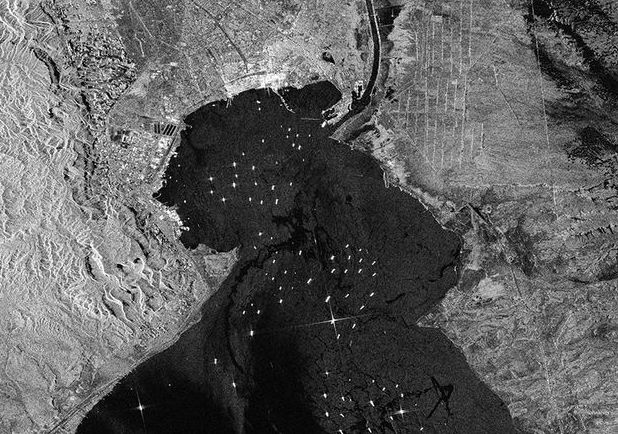 SATELLITE IMAGES SHOW JUST HOW BAD THE SUEZ CANAL TRAFFIC JAM IS BECOMING