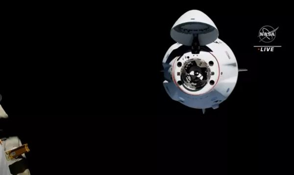 SPACEX'S FIRST REUSED CREW DRAGON DOCKS AT SPACE STATION WITH FOUR CREW-2 ASTRONAUTS