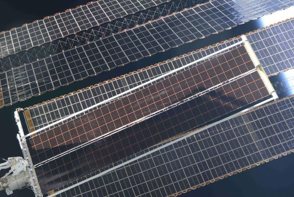 SPACEWALKERS UNFURL FIRST OF SIX NEW SPACE STATION SOLAR ARRAYS