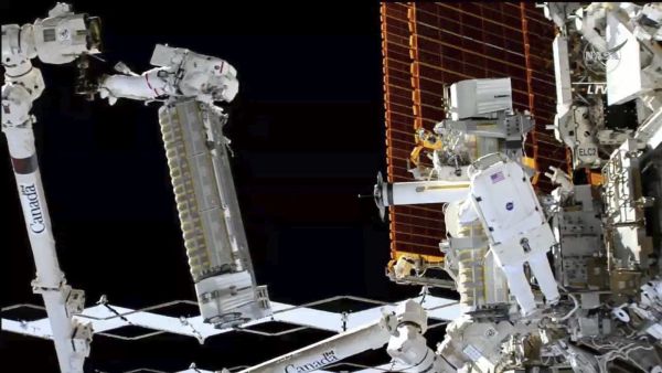 ASTRONAUTS INSTALL NEW SOLAR ARRAY OUTSIDE INTERNATIONAL SPACE STATION