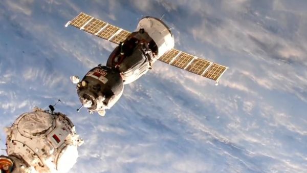ASTRONAUTS FLY REPLACEMENT SOYUZ CAPSULE TO NEW DOCKING PORT AT SPACE STATION